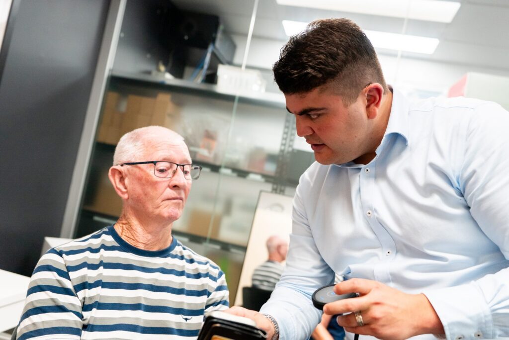 Audiologist talking a patient through cochlear implant options
