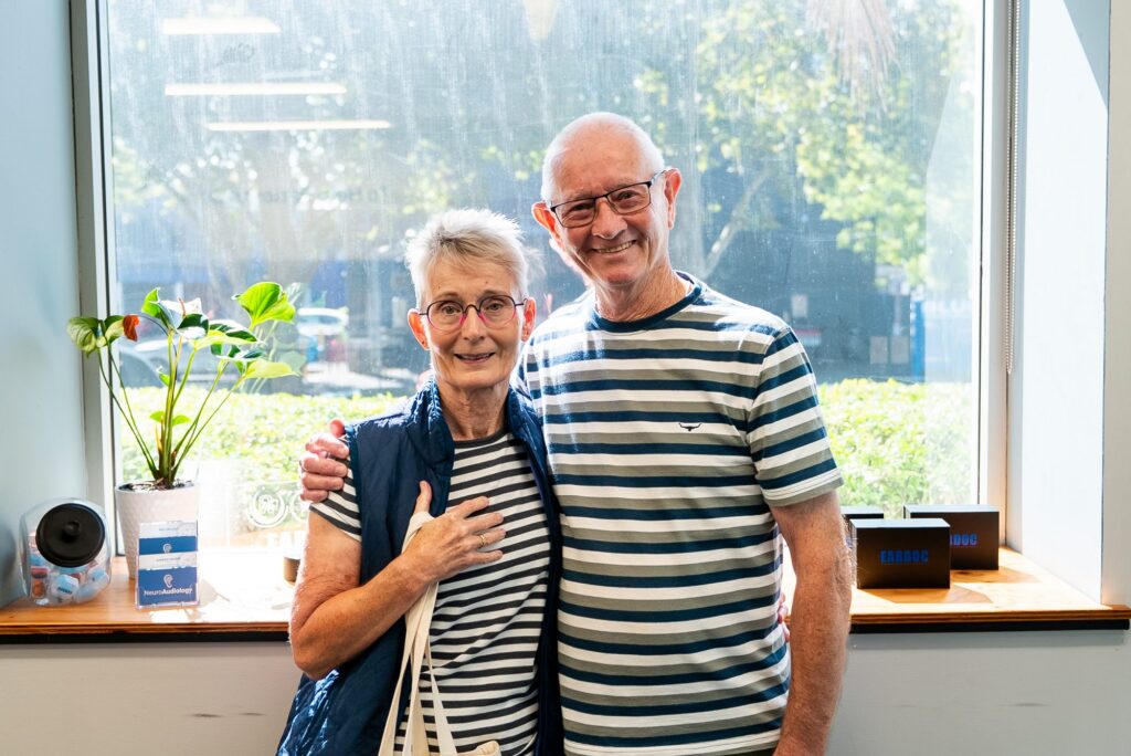 Smiling couple after better hearing